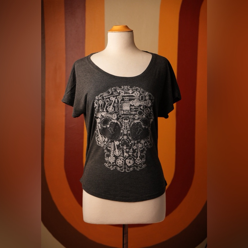 Oversized charcoal gray graphic tee shirt with key and locket skull art